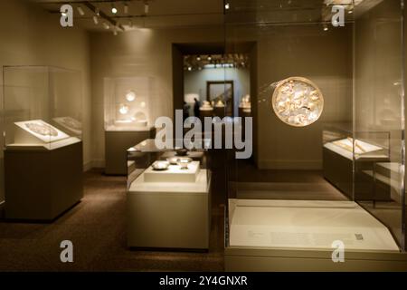 WASHINGTON DC, United States — An exhibit of ancient Persian metalware on display at the Arthur M. Sackler Gallery in Washington DC. The collection showcases intricate metalwork from various periods of Persian history, demonstrating the advanced craftsmanship and artistic traditions of ancient Iran. This exhibit is part of the Smithsonian Institution's extensive Asian art collection. Stock Photo