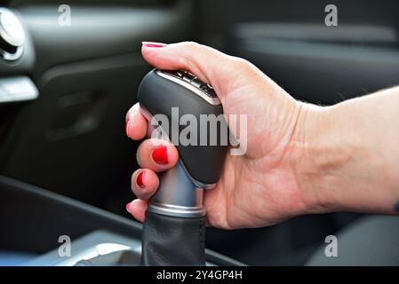 Woman shift gears in car Stock Photo