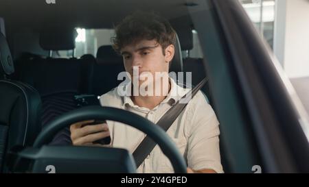 Caucasian confused sad driver upset puzzled male businessman frustrated man stressed business employer in car auto automobile parking lot traffic jam Stock Photo