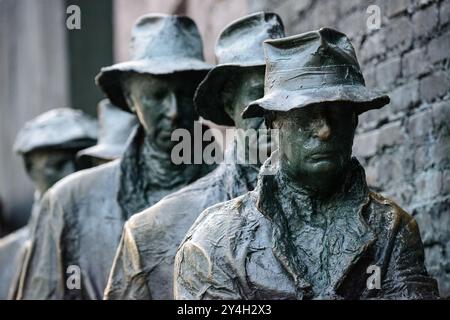 WASHINGTON DC, United States — Bronze statues depicting men in a bread line stand as part of the Franklin Delano Roosevelt Memorial. The sculptures, created by George Segal, represent the hardships of the Great Depression during FDR's presidency. Located along the Tidal Basin in West Potomac Park, the memorial opened in 1997 to honor America's 32nd president. Stock Photo