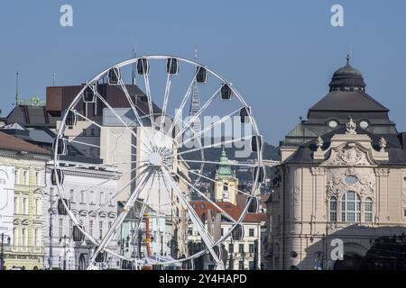 Bratislava Ferris wheel with reduta concert hall and TV tower in the distance Stock Photo