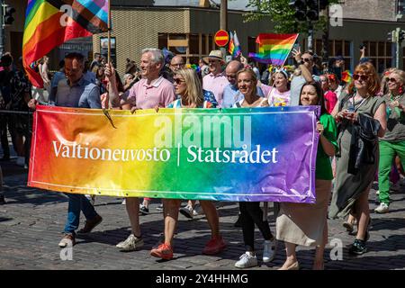 Members of Finnish Government marching with banner on Mannerheimintie at Helsinki Pride 2024 parade in Helsinki, Finland Stock Photo