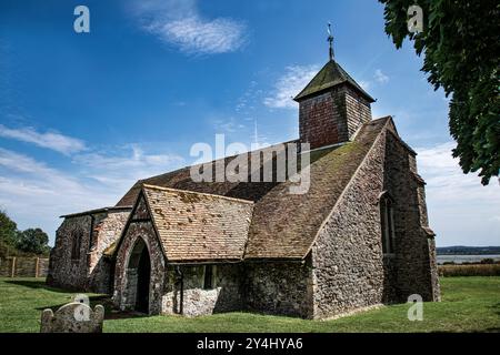 The Church of St Thomas the Apostle on the bank of the River Swale in Harty on the Isle of Sheppey in the county of Kent, United kingdom. Grade II. Stock Photo