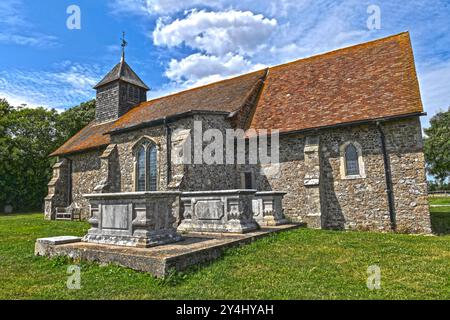 The Church of St Thomas the Apostle on the bank of the River Swale in Harty on the Isle of Sheppey in the county of Kent, United kingdom. Grade II. Stock Photo