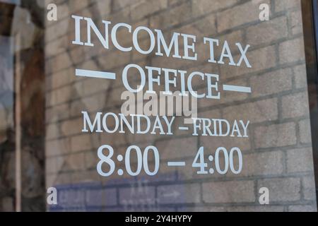 Income Tax Office sign on door Stock Photo
