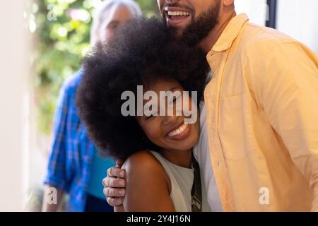 Hugging friend, smiling woman enjoying happy moment together indoors Stock Photo