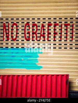 No Graffiti words spray painted on garage door Stock Photo