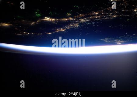 International Space Station, Earth Orbit. 15 August, 2024. A view from the International Space Station of the city lights of southern Thailand and Malaysia with the Malacca Strait on the top, from 261 miles above, August 15, 2024 in Earth Orbit. The Gulf of Thailand and the southern coast of Vietnam, at bottom right, are seen with the lights of Ho Chi Minh City. Night fishing boats, using LED green lights that attract plankton luring squid for capture can be seen on both the top and bottom as the white band of light shows the approaching orbital sunrise.  are pictured in both bodies of water C Stock Photo