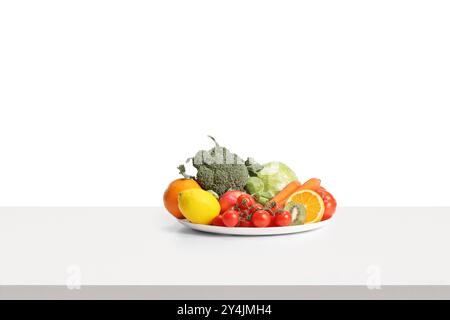 Plate of fruits and vegetables isolated on white background Stock Photo