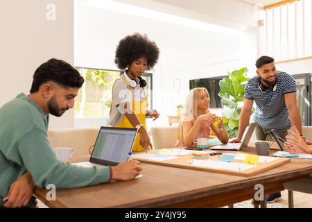 Start up business, Collaborating on project, diverse group of friends using laptops and sticky notes Stock Photo