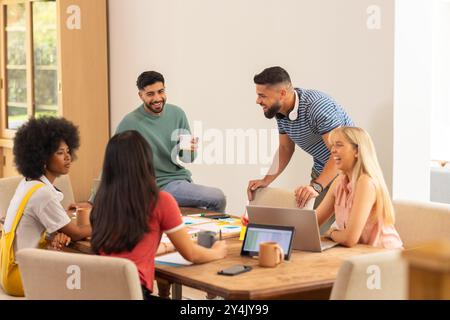 Start up business, Collaborating on project, group of young friends working together at table Stock Photo