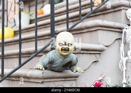 Spooky zombie baby. Halloween outdoor zombie baby decoration. Happy Halloween zombie baby. Trick or treat. Celebrate All Hallows holiday. All Hallows Stock Photo