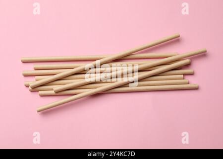 Bamboo drinking straws on pink background, top view Stock Photo