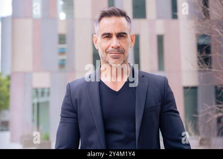 portrait of smiling businessman looking at camera outdoors Stock Photo