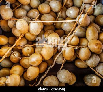 Bunch of fresh dates for sale on a farmers market Stock Photo