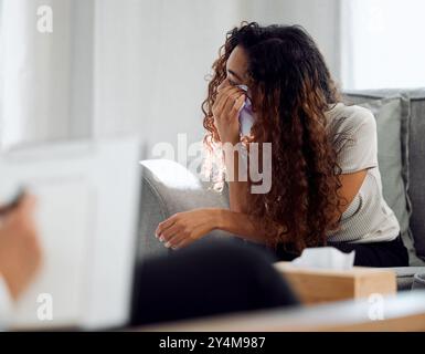 Sad girl crying while writing in her diary, sitting alone under tree in ...
