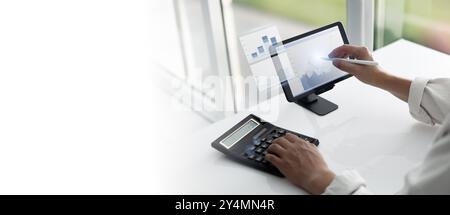 Financial Analysis Using Tablet and Calculator Stock Photo