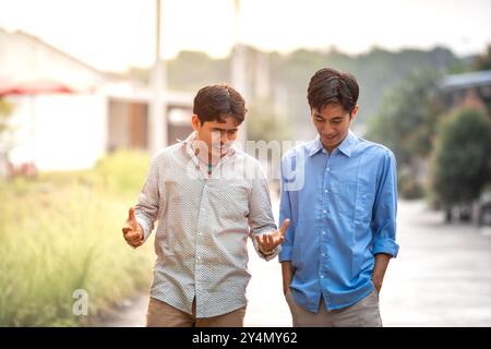 Young businessman discussing for their business. Happy young executive having discussion for next project. Two male business partner talk each other. Stock Photo
