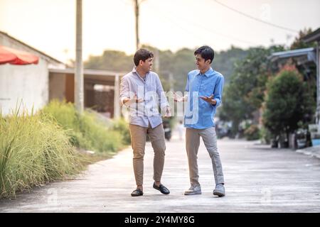 Young businessman discussing for their business. Happy young executive having discussion for next project. Two male business partner talk each other. Stock Photo