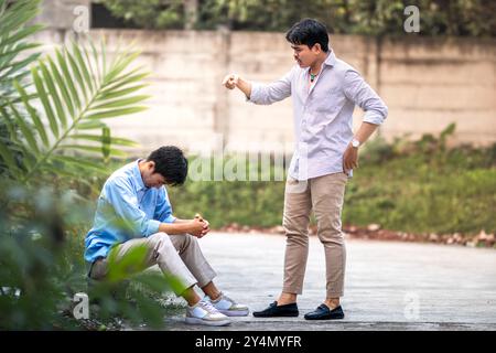 An employee being scolded by his boss. A man scolding and yelling at another man for making a mistake. Stock Photo