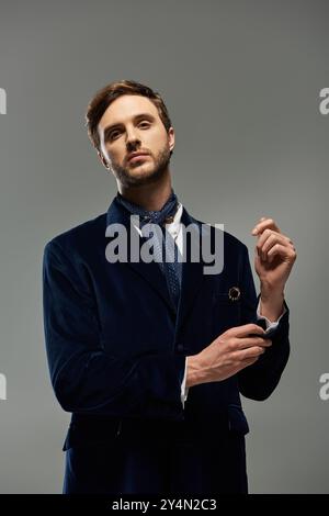 A handsome dandy stands confidently, exuding charm and elegance in a stylish outfit. Stock Photo