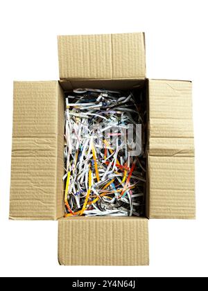 Isolated carton box on white background. Flat lay a long shape carton box with shredded paper from magazines. Stock Photo