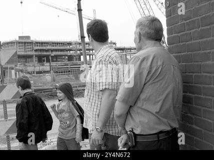 Two Caucasian men watching the progress at the Minnesota Twins ballpark construction site in Minneapolis, Minnesota, USA. Stock Photo