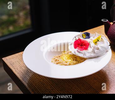 meringue on plate and almonds with vanilla custard Stock Photo