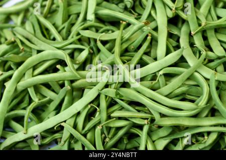 Detailed image of fresh green beans with a focus on their texture and intense color. Excellent for representing themes of healthy eating, organic prod Stock Photo