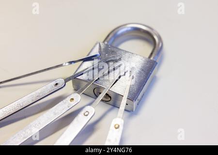 Oberursel, Germany. 18th Sep, 2024. Lockpicking tool rests on a padlock. For the members of the "Sportfreunde der Sperrtechnik" association, opening locks of all kinds without a key is a sporting challenge. Credit: Lando Hass/dpa/Ģ����ý Live News Stock Photo