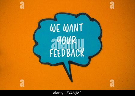 We want your feedback message written on blue paper speech bubble with orange background. Conceptual we want your feedback symbol. Copy space. Stock Photo