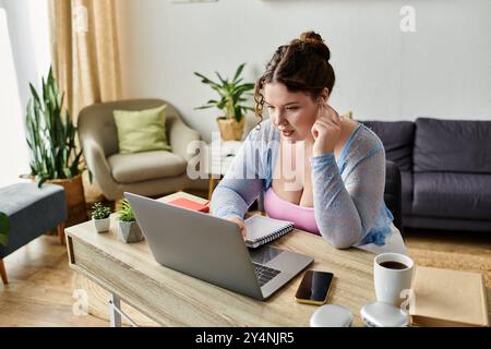 Hard working young woman in cozy homewear working from home, remote. Stock Photo
