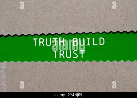 Truth build trust message written on ripped torn paper on green background. Conceptual truth build trust symbol. Copy space. Stock Photo