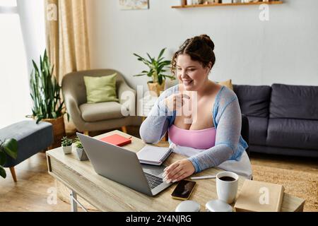 Dedicated young woman in cozy homewear working from home, remote. Stock Photo