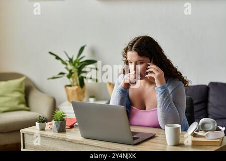 Concentrated woman with dark hair working at home. Stock Photo