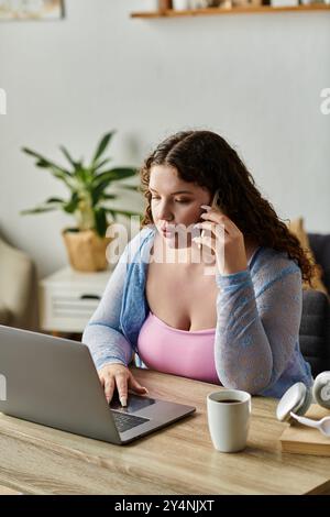Focused woman with dark hair working at home. Stock Photo