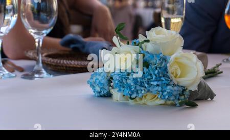 Close up of white roses centerpiece against blurred party background during daytime Stock Photo
