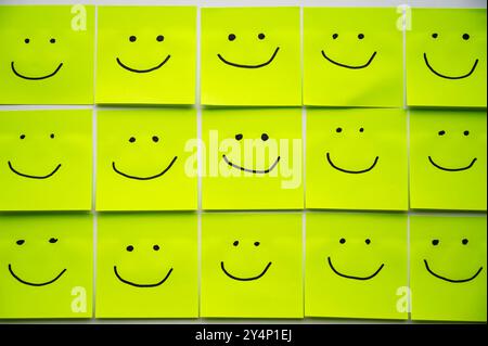 Colored sheets of paper, with smiley faces drawn on them, inclusion, harmony and welcome. Stock Photo