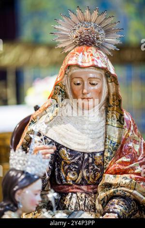 Seville, Spain, May 31 2009, Saint Anne holds the Virgin Mary in beautifully detailed sculptures within the Church of San Lorenzo, showcasing Baroque Stock Photo