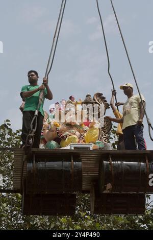 Vadodara, Gujarat / India - September 15, 2016 : A group of people taking the statues of the Lord Shree Ganesha to dissolve into the lake water on the Stock Photo