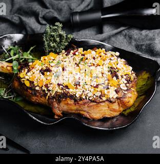 Barbecue tomahawk steak on black plate Stock Photo