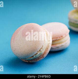 Sweet and colorful macaroons on blue background Stock Photo