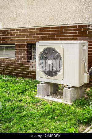 New air source heat pump installed outside of family house Stock Photo