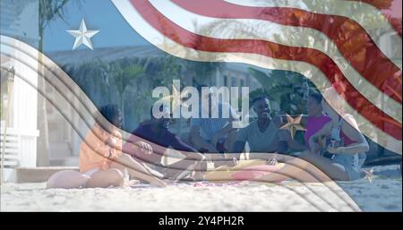Image of american flag elements over happy diverse friends hanging out on sunny beach Stock Photo
