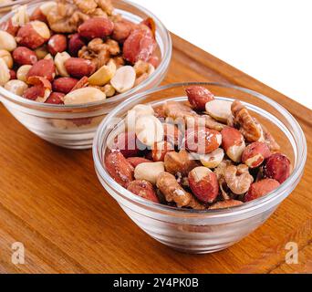 Assorted nuts in a glass bowls on wooden Stock Photo