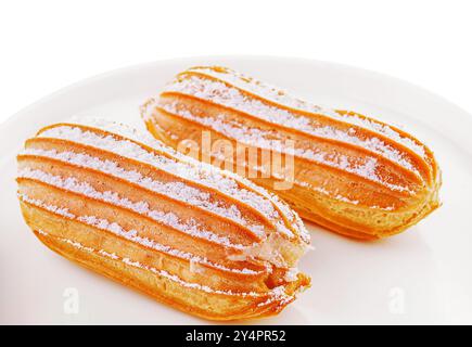 two eclairs on white plate isolated Stock Photo