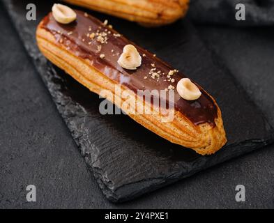 french eclairs with chocolate and hazelnuts Stock Photo
