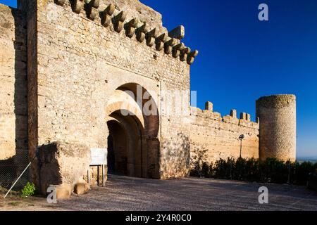 Discover the impressive entrance of the former Moorish Alcazar in Carmona, showcasing ancient architecture under a clear blue sky. Stock Photo