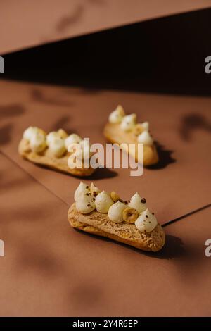 eclairs with whipped cream and hazelnuts Stock Photo