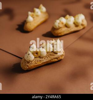 eclairs with whipped cream and hazelnuts Stock Photo